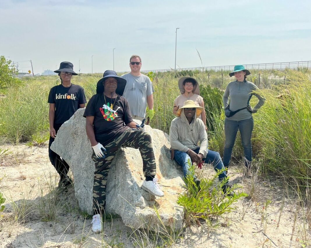 group of volunteers with beach grass